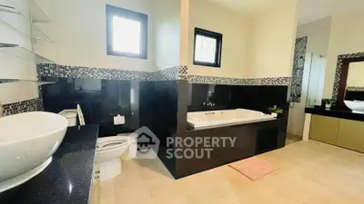 Spacious modern bathroom with elegant bathtub and stylish fixtures.