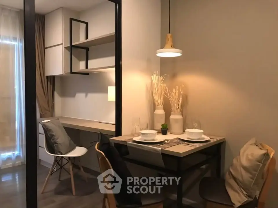 Cozy dining area with modern decor and stylish lighting in a contemporary apartment.