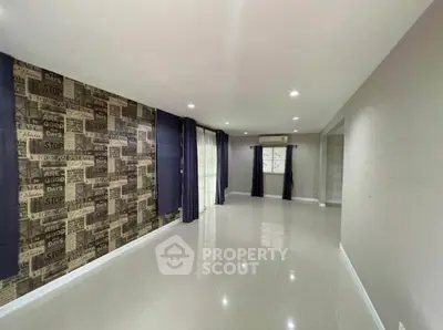 Spacious living room with modern decor and large windows for natural light.