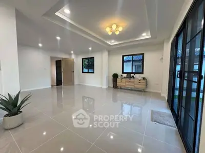 Spacious modern living room with elegant lighting and large windows