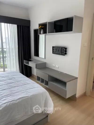 Modern bedroom with sleek storage and large window for natural light