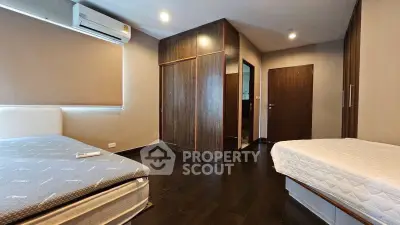 Spacious bedroom with modern design and ample storage in a stylish apartment.