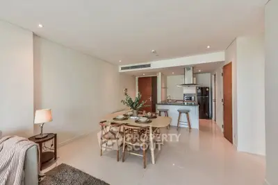 Modern open-plan living and dining area with stylish kitchen in a contemporary apartment.