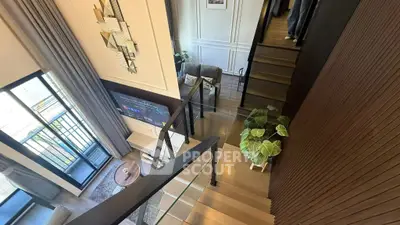 Modern duplex interior with stylish staircase and cozy living area