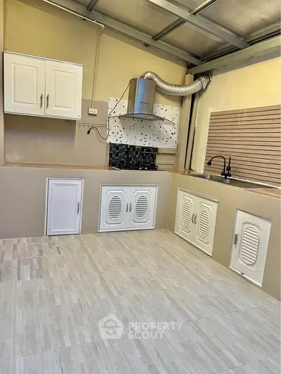 Modern kitchen with sleek cabinetry and stylish backsplash in a contemporary home.