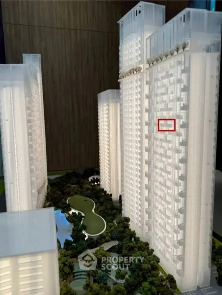 Stunning architectural model of modern high-rise residential complex with lush green landscaping.