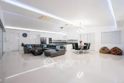 Spacious modern living room with open kitchen and stylish decor