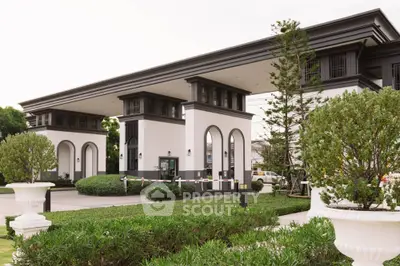 Elegant gated entrance of luxury residential community with manicured landscaping