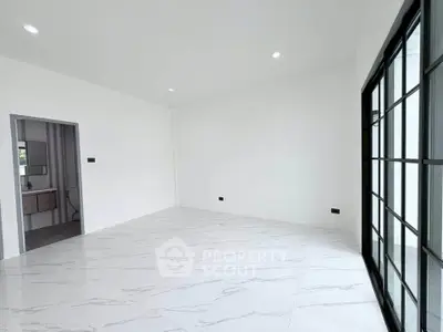 Spacious modern living room with large windows and sleek tile flooring