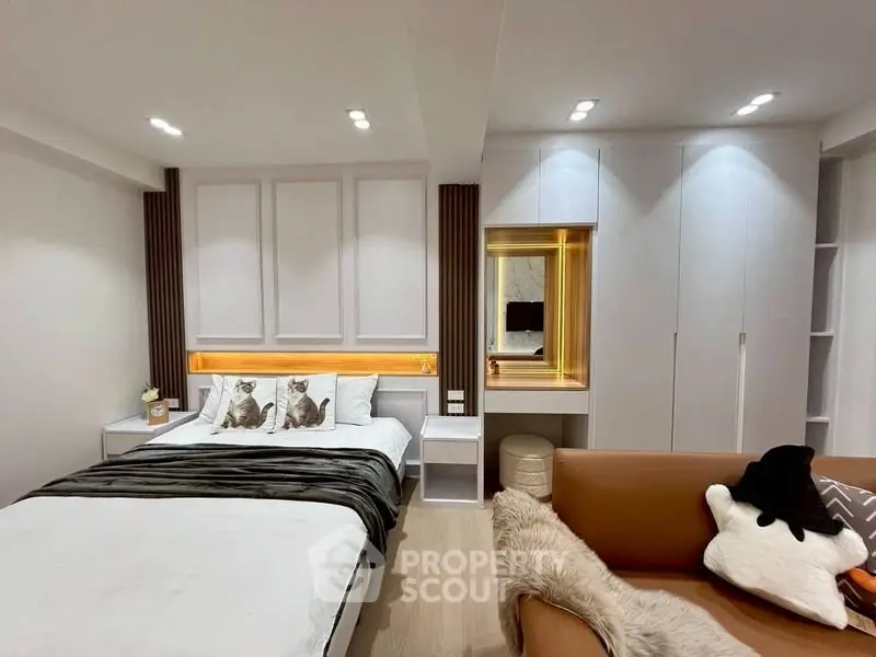 Luxurious modern bedroom with elegant decor and cozy seating area