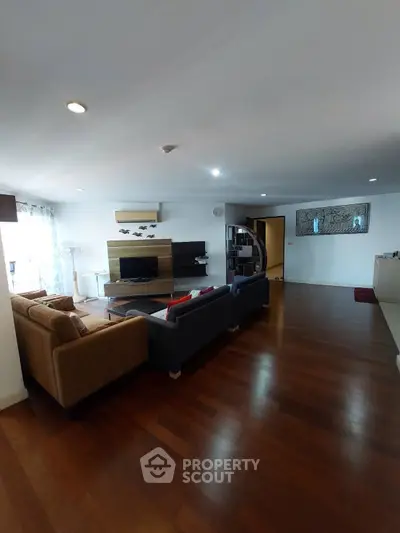 Spacious living room with modern decor and hardwood flooring