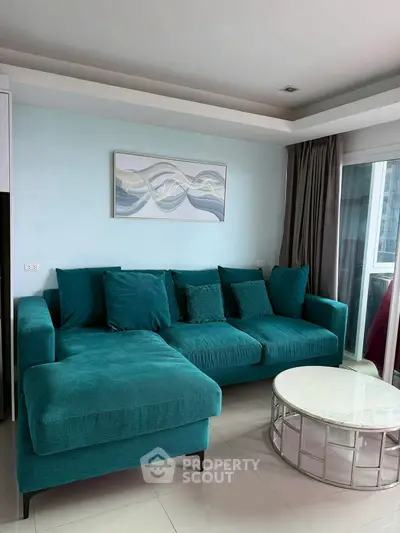 Modern living room with teal sectional sofa and stylish decor