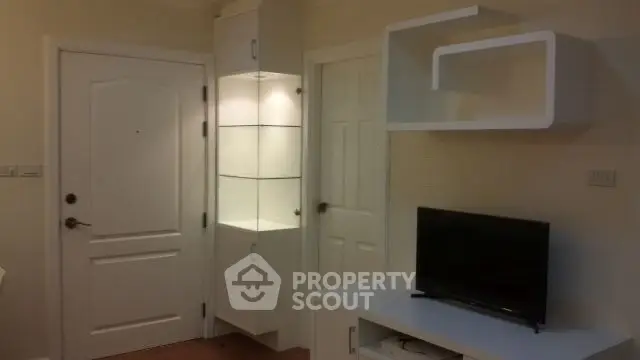 Modern living room with sleek white furniture and built-in shelving