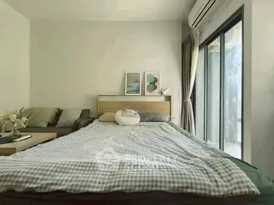 Cozy bedroom with modern decor and large window for natural light