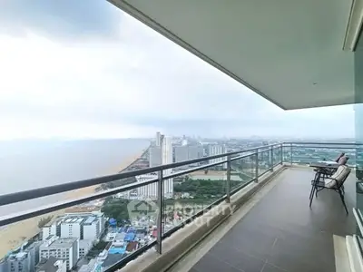 Stunning high-rise balcony with breathtaking ocean and city views, perfect for relaxation.