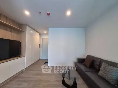 Modern living room with sleek furniture and built-in storage, perfect for urban living.