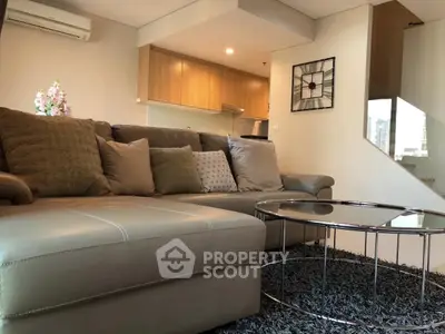 Modern living room with stylish decor and open kitchen layout