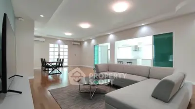 Spacious modern living room with elegant furniture and open layout, perfect for entertaining.