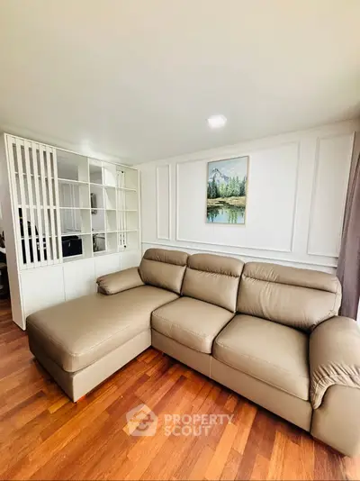 Modern living room with elegant beige sofa and stylish wooden flooring