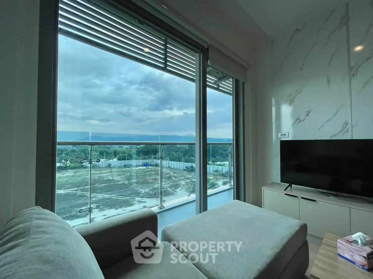 Modern living room with stunning balcony view and sleek interior design.