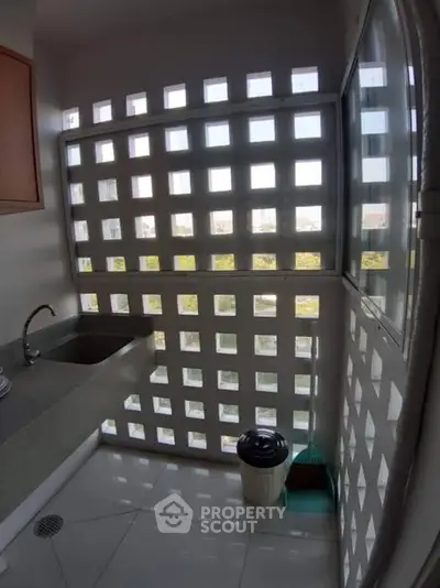 Modern kitchen with unique window design and sleek countertop