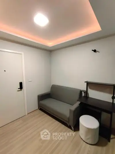 Modern living room with sleek sofa and stylish lighting, perfect for cozy urban living.