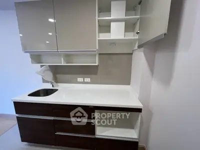 Modern kitchen with sleek cabinets and built-in sink, perfect for urban living.