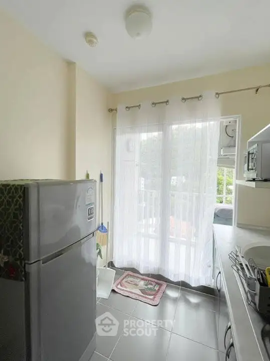 Bright kitchen with modern appliances and balcony access