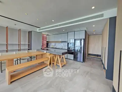 Modern kitchen with sleek design and open layout, featuring a stylish island and ample natural light.