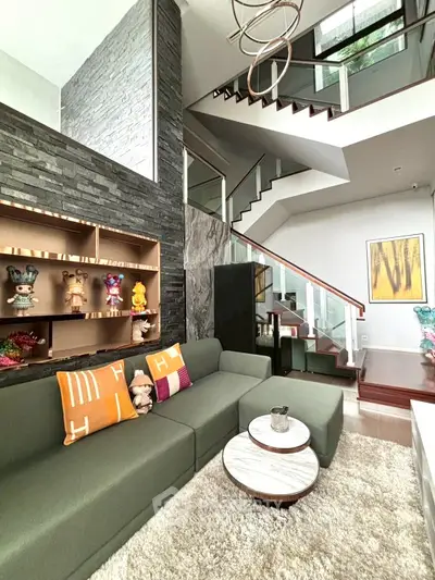 Modern living room with stylish staircase and cozy seating area