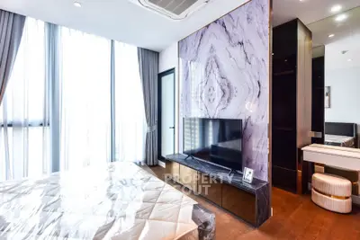 Luxurious modern bedroom with marble accent wall and large windows