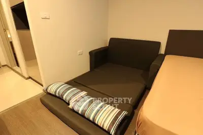 Cozy bedroom with foldable sofa bed and modern decor