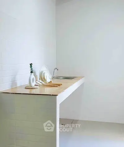 Minimalist kitchen with sleek white tiles and wooden countertop