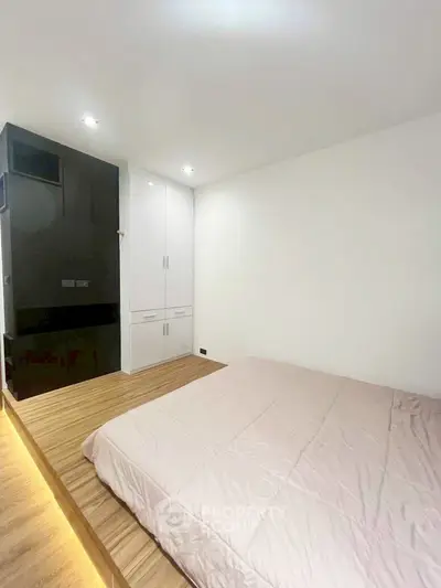 Modern minimalist bedroom with sleek built-in wardrobe and cozy lighting