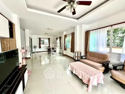 Spacious living room with modern furniture and large windows for natural light.