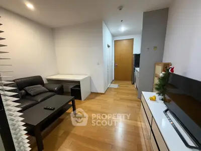 Modern living room with sleek furniture and wooden flooring in a cozy apartment.