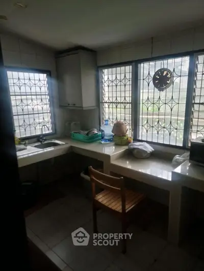 Cozy kitchen with natural light and tiled countertops
