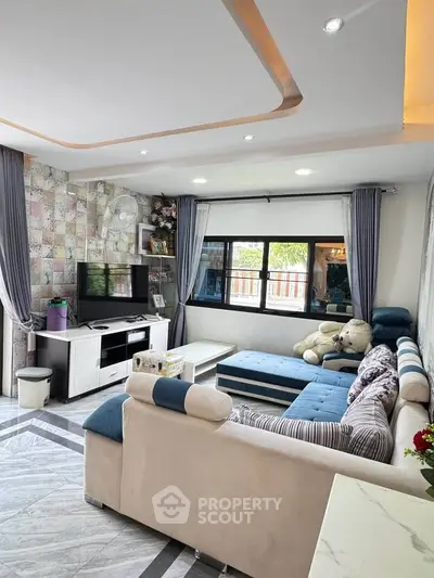 Stylish living room with modern decor and large windows offering natural light.