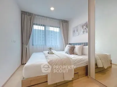 Modern bedroom with cozy decor and large window for natural light