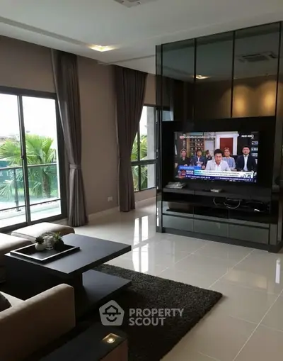 Modern living room with large windows and sleek furniture, perfect for relaxation.