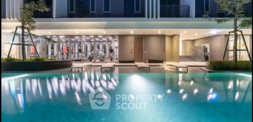 Luxurious modern poolside view with gym facilities in upscale residential complex