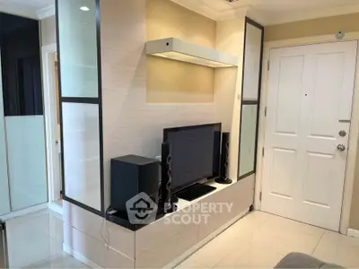 Modern living room with sleek TV setup and stylish storage solutions.