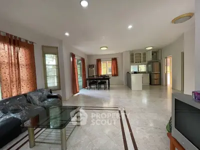 Spacious open-layout living room with modern kitchen and dining area