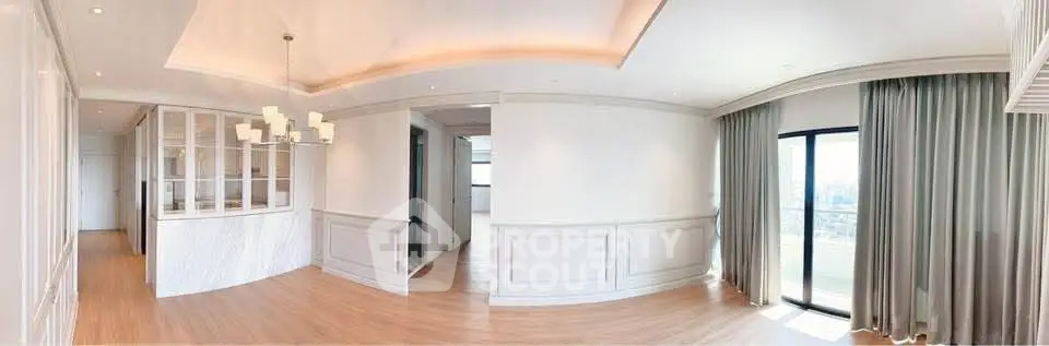 Spacious and elegant living room with panoramic windows and modern lighting