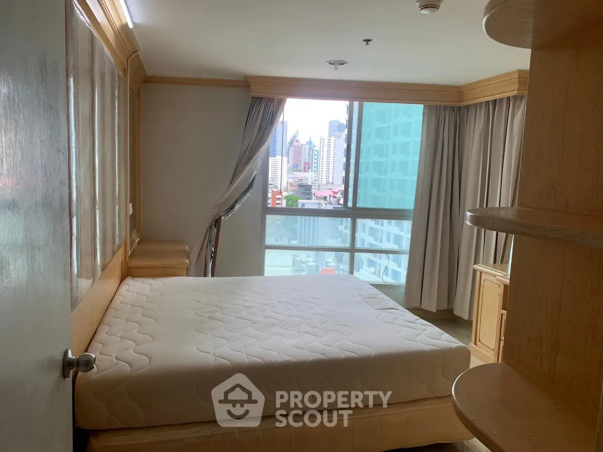 Spacious bedroom with city view and natural light in modern apartment