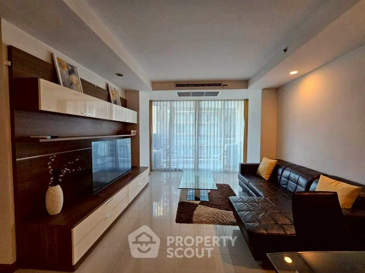 Modern living room with sleek furniture and large windows offering ample natural light.
