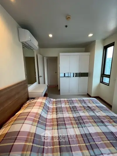 Cozy bedroom with modern decor and ample natural light