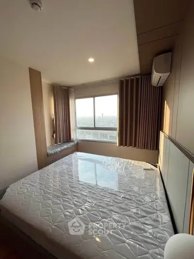 Spacious bedroom with large window offering stunning city views, featuring modern design and ample natural light.