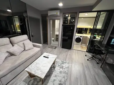 Modern living room with stylish decor, open layout, and in-unit laundry for urban convenience.