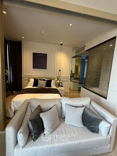Luxurious modern bedroom with cozy sofa and elegant decor
